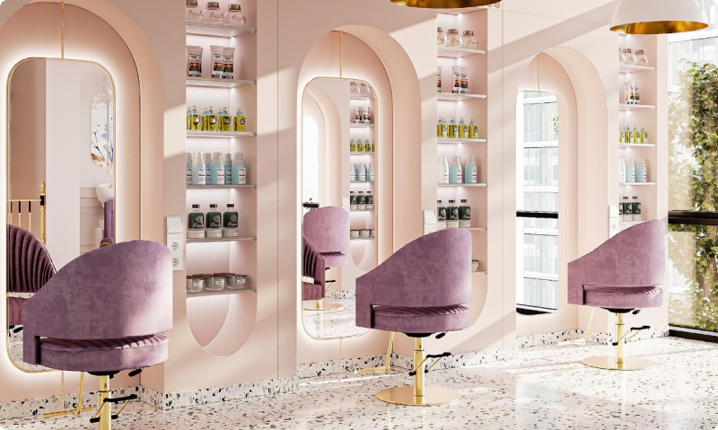 In the image, we see three chairs in medium to dark shades of gray. The depicted environment is clean, with light tones leaning towards shades of pink and beige. The space exudes elegance and refinement. On the walls of the location, there are glass displays and tubes of creams and related products, neatly arranged on the shelves. Details in gold and silver can be observed, further accentuating the sophistication and plenitude of the ambiance.